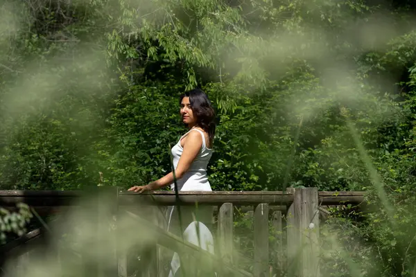 Woman walking mindfully on a sunlit nature path